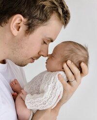 Dad and son image dressed in white.