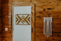 Bohemian style macrame wall hanging in cabin.