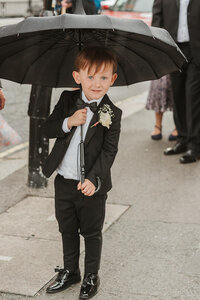 page boy standing in London street 