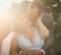 Young bride and groom sharing a joyful moment at The Wranch in Lindsay, California.