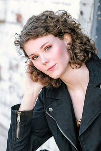 Teenage girl standing in tall grasses