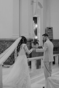 groom leading bride down the stairs at their Church wedding taken by Oklahoma Photographer