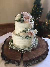 bright flowers arranged on wedding cake