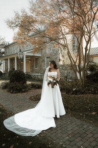 bride with wedding veil and wedding dress posed for wedding photography at bortner valley wedding venue in upper co maryland