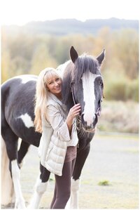 woman hugs her black and white paint horse for Montana equine photoshoot