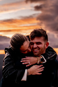 On a romantic proposal at Desert View Watchtower, a man kneels before his partner with the expansive Grand Canyon stretching out behind them, the moment captured in perfect light.