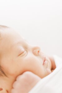 profile shot of sleeping baby during newborn photo session with Amanda Carter Photography