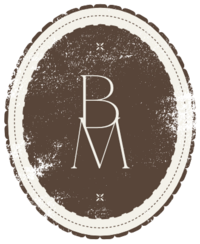 Brown and cream distressed sublogo with scalloped edges and dotted lines in an oval shape with BM in the middle and the submark above and below.