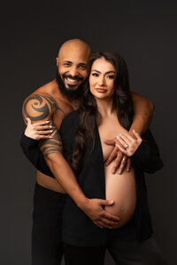 family of 3 posing for classic studio family session in phoenix