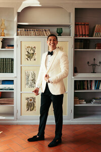 The groom getting ready in an old Tuscany villa, capturing the rustic charm and historic allure of the surroundings as he prepares for the wedding day