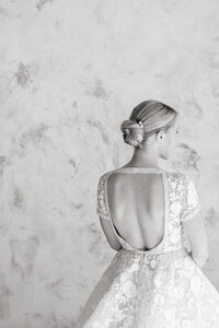 a bride with a low back wedding dress posing during getting ready photos