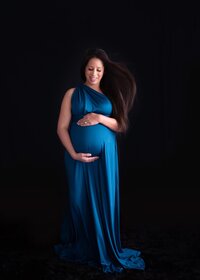 maternity portrait of mom in a blue dress taken in yorktown virginia studio