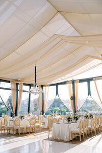 Wedding reception at The Water Works in Philadelphia at sunset, with elegant decor, glowing lights, and views of the Schuylkill River.