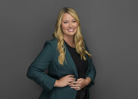 Professional personal branding headshot of a woman in a turquoise suit smiling at the camera during a business-style photo session in South Bend and Laporte Indiana.