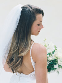 Elegant indoor wedding ceremony at The Jefferson Hotel in Washington DC with floral arch and crystal chandeliers, photographed by a luxury DC wedding photographer