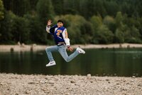High school senior boy standing on a boardwalk in Marymoor Park