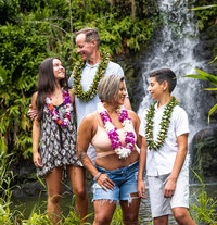 Family wearing flower leis by family photographer in Big Island Hawaii