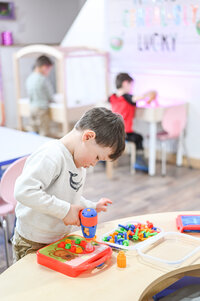 Student exploring fine motor station at House of Parker Preschool in Gorham Me