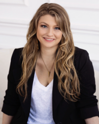 Nicole, a young white woman with beachy blond hair, black all-business blazer and smart gold necklace