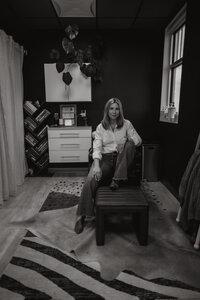 Black and white of hair stylist sitting in hair washing chair 