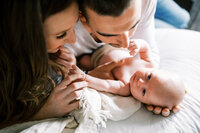 Young couple snuggling up to newborn baby in Johnson City, Tennessee by Danielle Defayette