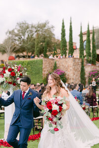 Bride and groom walking down the aisle at Bella Collina