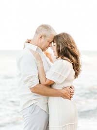 Erie County family photographers, Greg and Jennifer Hall, by a lake.