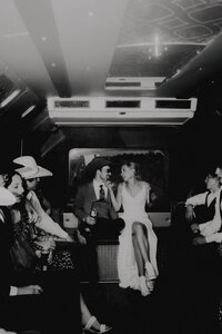 couple having fun together on their party bus on their wedding day