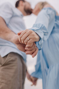 Engagement photos in Florida of a couple from underneath capturing the wedding ring