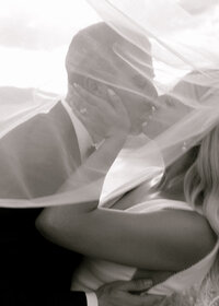black and white veil photo of wedding couple