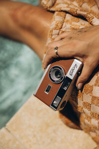 Brand photoshoot for retro film camera sitting by the waters edge