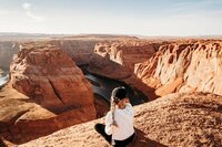 a sedona elopement photographer sitting on horseshoe bend in arizona