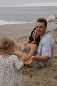 family of 3 on beach