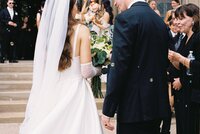 bride and groom conversing at wedding, white wedding dress, black tuxedo, beautiful flowers, destination wedding phography