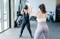Christina working with a client to build strength