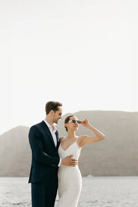 Bride and groom wedding on a catamaran in Santorini, Greece