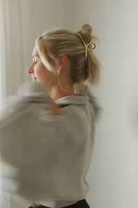 Woman practicing Kundalini breathwork with twisting motion to awaken energy and clear the spine