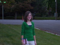 Young girl holding a notebook and pen on her first day of school.