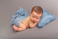 newborn baby sleeping with light blue scarf