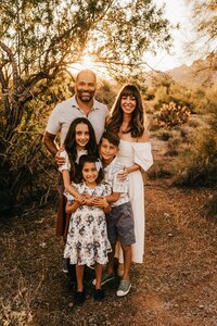 family of 5 posing for family photoshoot in phoenix arizona at sunset