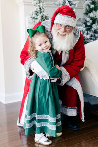 Santa and girl posing smiling together