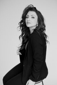 Black and white headshot of amy in a studio