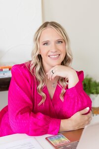 Heather wearing a pink sweater, smiling