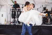 Married couple kissing during a first dance lift