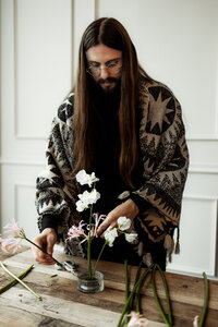 Wedding florist arranging Ikebana style table decor in San Francisco, California