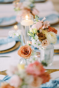 Roses and spring flowers decorate a wedding table in Texas.