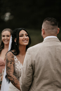Bride smiles at groom during their Vancouver BC wedding ceremony