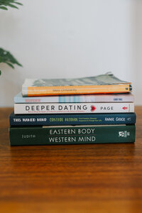 Stack of books on a wood desk