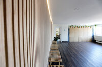 Organized yoga mats on wall in Bethesda-based studio space