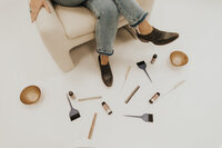 A flat lay of brushes and brand elements showcasing Emily’s new identity.